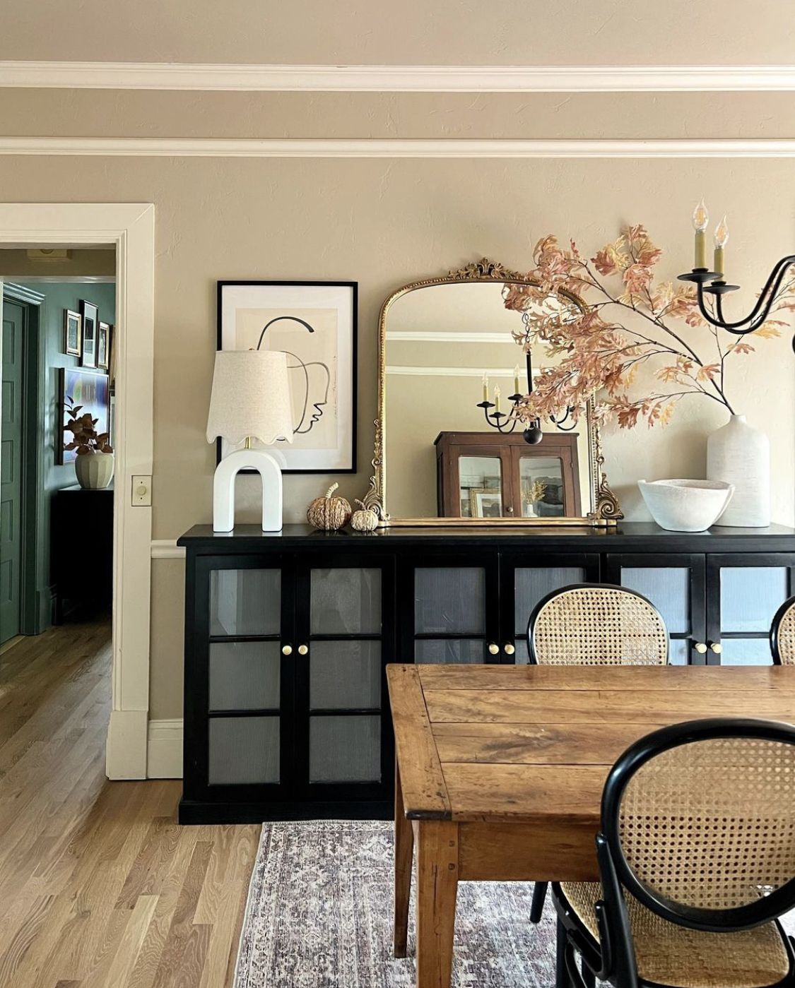 Eclectic Dining Room with Black Buffet and Warm Wood Table