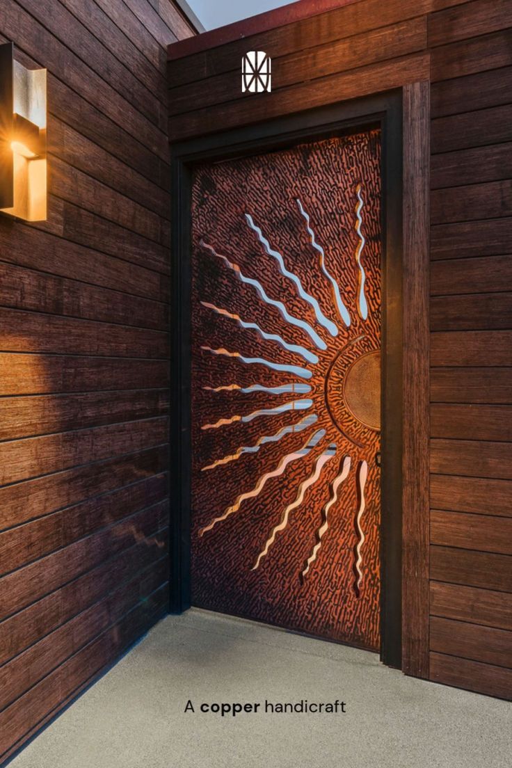 Modern Entry Door with Copper Sunburst Design and Wood Siding