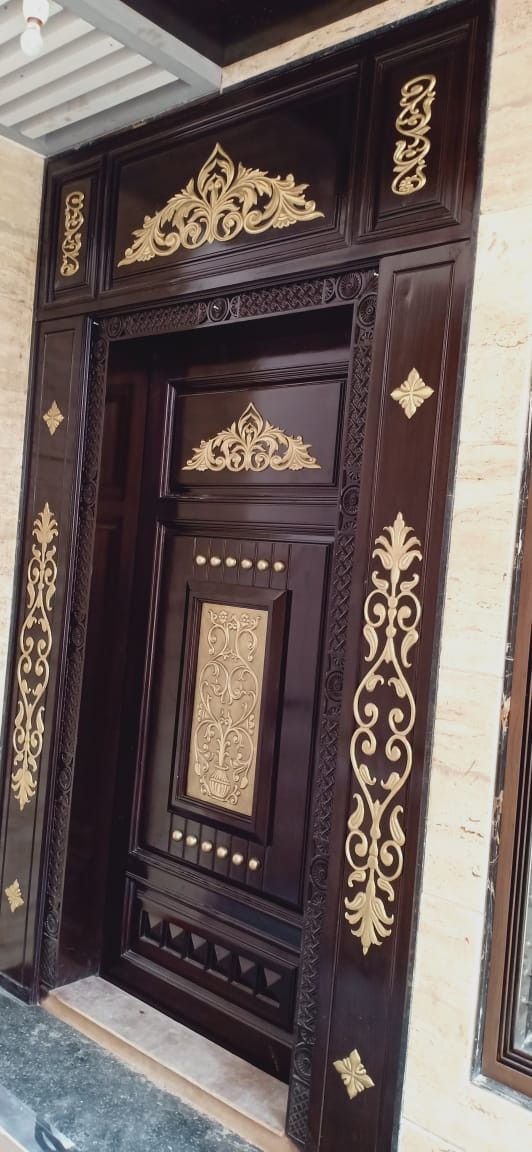 Luxurious Ornate Dark Wood Entry Door with Gold Accents